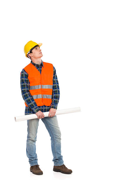 真剣な建設作業員ロール紙を計画しています。 - construction worker building contractor craftsperson full length ストックフォトと画像