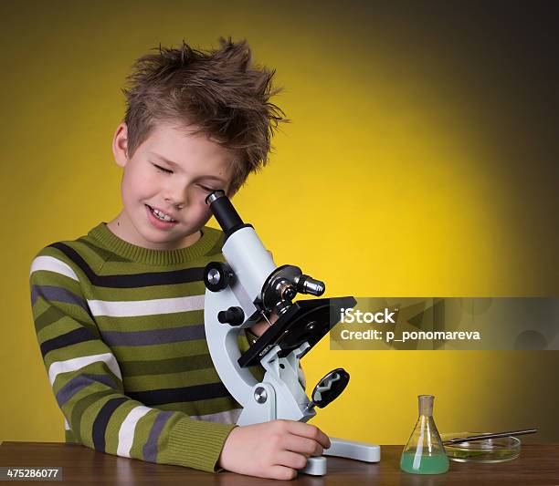 The Boy With A Microscope On A Yellow Background Education Stock Photo - Download Image Now