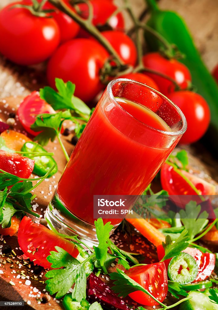 Fresh juice from mix of vegetables with vegetables and herbs Fresh juice from the mix of vegetables with vegetables and herbs on a wooden table, selective focusFresh juice from the mix of vegetables with vegetables and herbs on a wooden table, selective focus 2015 Stock Photo