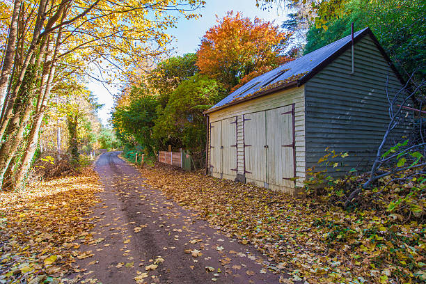 istock Autumn landscape with road and a barn 475289410