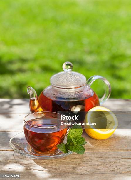 Breakfast Tea On Garden Table Stock Photo - Download Image Now - 2015, Black Tea, Blurred Motion