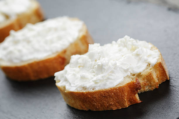 istock crunchy baguette slices with cream cheese on slate board 475292136
