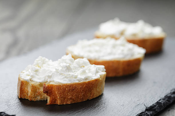 istock crunchy baguette slices with cream cheese on slate board 475292140