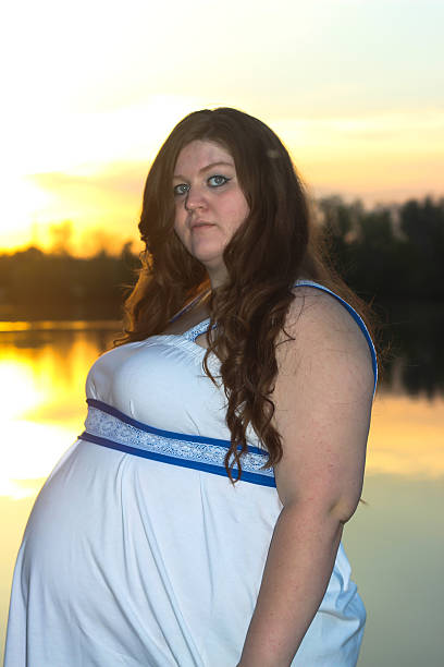 istock Pregnant Woman at Sunset 475292296