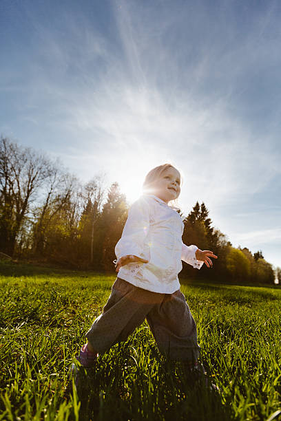 istock Little girl walks in the park 475292502