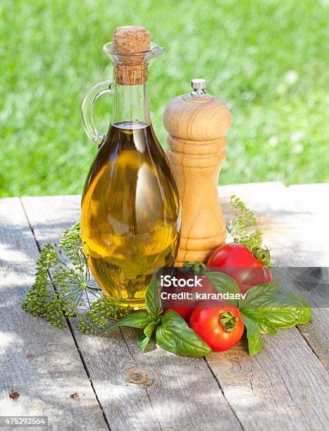 Olive Oil Bottle Pepper Shaker Basil And Ripe Tomatoes Stock Photo - Download Image Now
