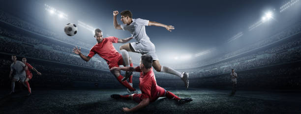 istock Soccer player kicking ball in stadium 475292666