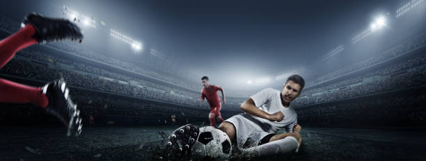 istock Soccer player kicking ball in stadium 475292670