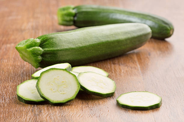 istock green zucchini on wooden table 475292834