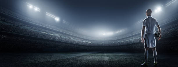 istock Soccer player with ball in stadium 475293000