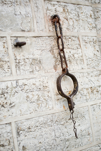 Shackles hanging on a stone wall