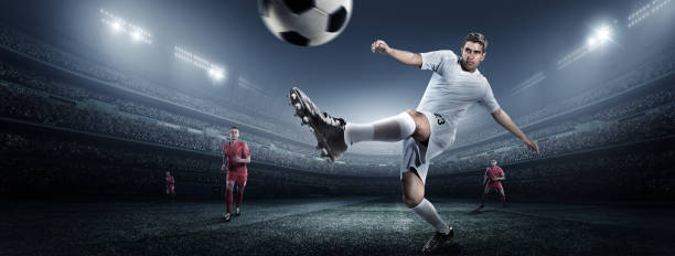 istock Soccer player kicking ball in stadium 475293388