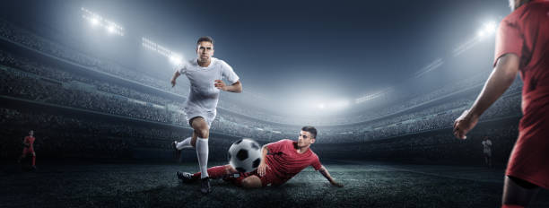 istock Soccer player kicking ball in stadium 475293408
