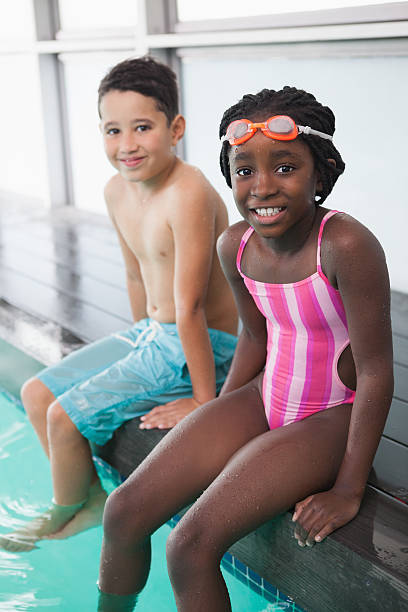 istock Cute little kids sitting poolside 475294090