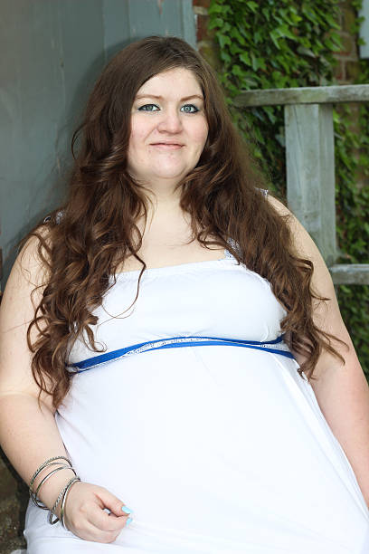 istock Pregnant Woman in Third Trimester Poses For Camera 475294682