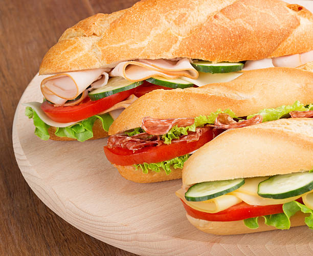 istock submarine sandwiches on a cutting board 475294942