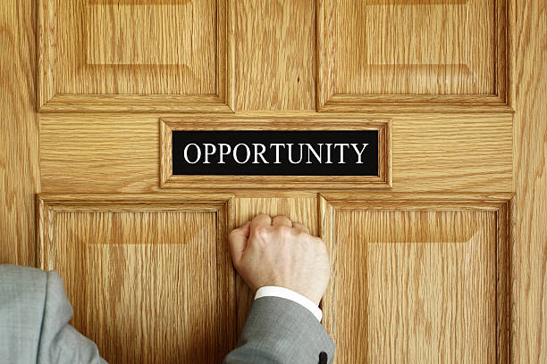 knocking on the door to opportunity Businessman knocking on a door to "Opportunity" office concept for aspirations, progress meeting or promotion knocking on door stock pictures, royalty-free photos & images