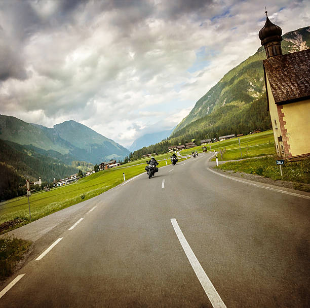 istock Biker race across mountainous village 475297856
