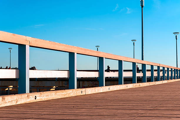 istock Wooden quayside in rays of evening sunlight. 475301384