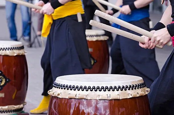 Photo of Group of musicians are playing on traditional japanese percussion instrument