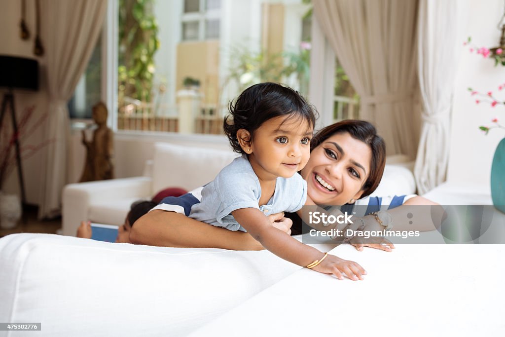 Playing at home Cute little girl and her beautiful mother playing at home Family Stock Photo