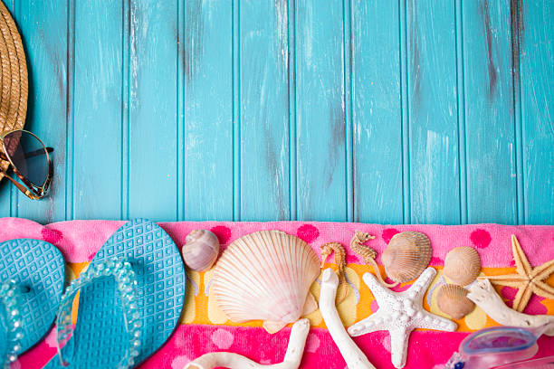 istock Summer vacation scene. Seashells, sandals on beach towel. Blue background. 475303308