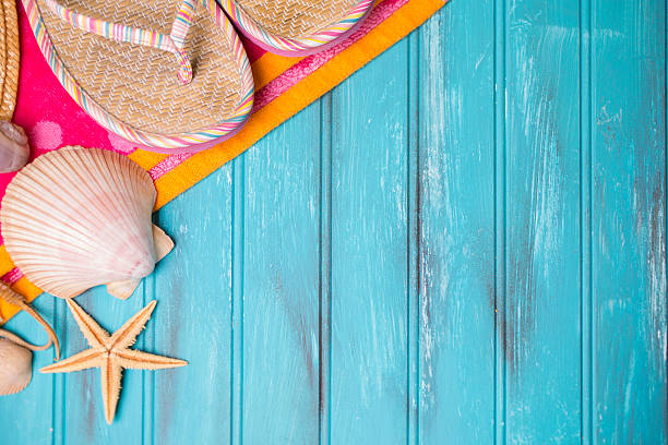 istock Summer vacation scene. Seashells, sandals on beach towel. Blue background. 475303550