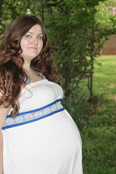istock Pregnant Woman Poses For Camera 475303564