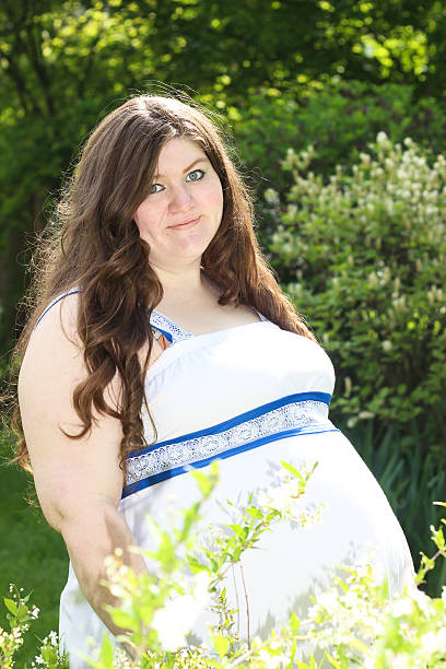 istock Pregnant Woman Grins For Camera 475304190