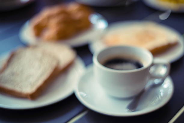 istock lens Blur Croissant Breakfast served with black coffee and break 475304252