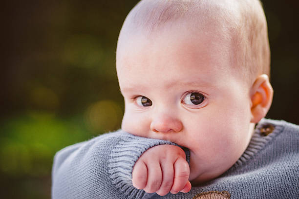 istock Baby boy sitting outside in sun 475306436