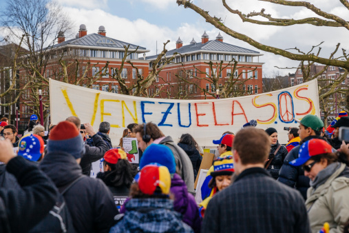 Amsterdam, The Netherlands – February 22, 2014: People protesting against the dictatorship of president Maduro from Venezuela and for the human rights. This photo was taken in Amsterdam The Netherlands at Museumplein on Feb 22nd 2014.