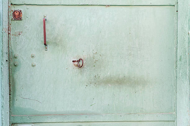 green metal door  texture with a keyhole. Vintage metal texture. stock photo