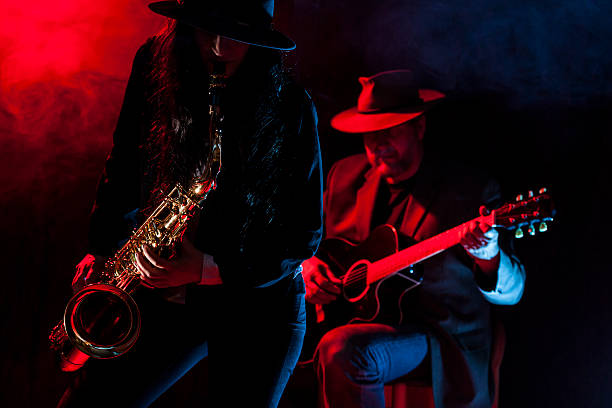Saxophone and Guitar Lady saxophonist and a guitarist guitarist photos stock pictures, royalty-free photos & images