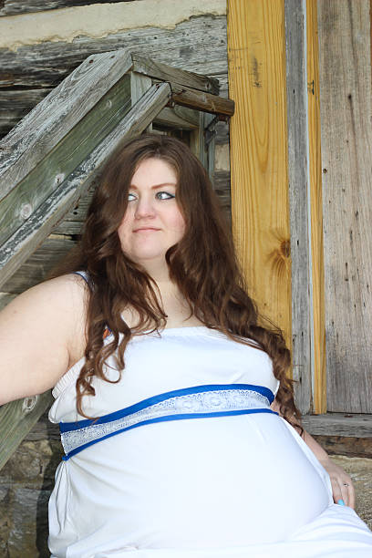 istock Pregnant Woman Sitting on Wood Steps 475312408