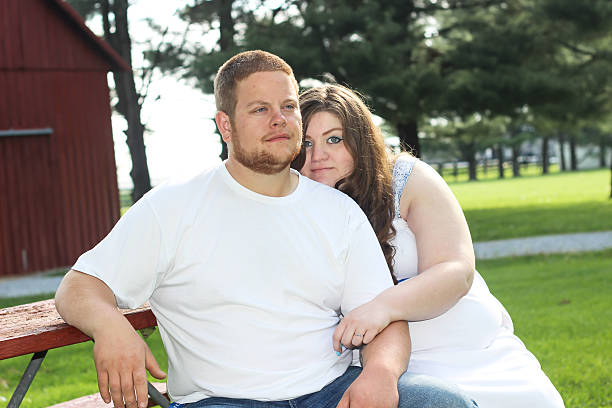 istock Pregnant Wife Holds Husband at Picnic Table 475313670