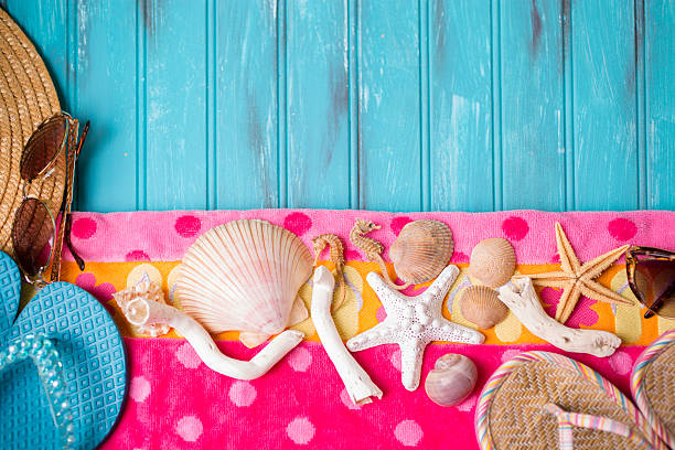 istock Summer vacation scene. Seashells on beach towel. Blue background. 475314964