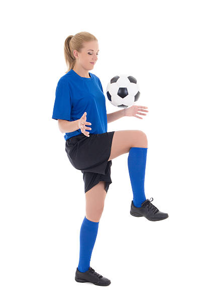 istock female soccer player in blue uniform playing with ball isolated 475316951