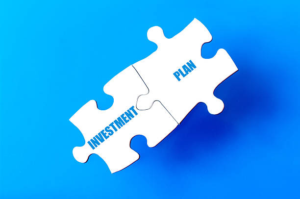 istock Connected puzzle pieces with words INVESTMENT and PLAN 475317270