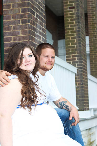 istock Pregnant Wife Poses With Husband on House Steps 475317516