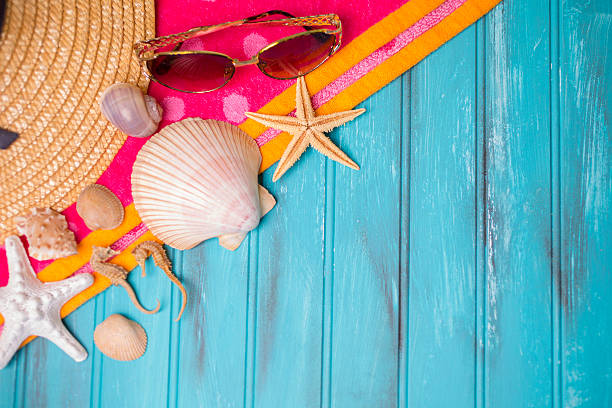 istock Summer vacation scene. Seashells on beach towel. Blue background. 475318798
