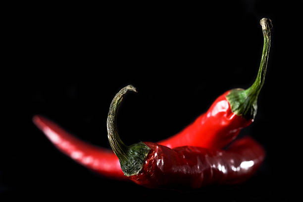 istock Chili in red color on back blackground 475319522