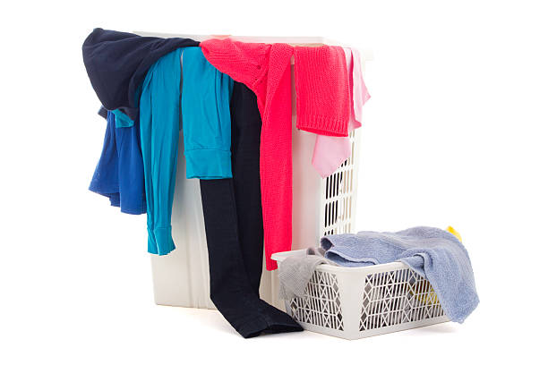 istock colorful dirty clothes in a laundry basket on white background 475323349