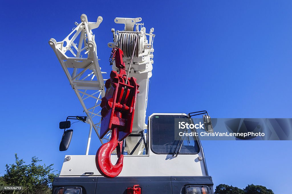 Mobile Crane Red White Hook Mobile diesel hydraulic heavy duty operated crane painted red hoist hook and white body with driver operator canopy's for rigging lifting engineering operations. Colors Stock Photo