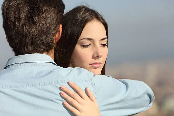 Photo of Sad woman hugging her boyfriend couple problems