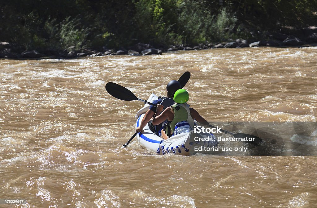 Colorado Kayakers Glenwood Canyon, CO, United States - September 16, 2013: Middle-aged couple navigate the muddy waters of the Colorado River in an inflatable kayak. Adult Stock Photo