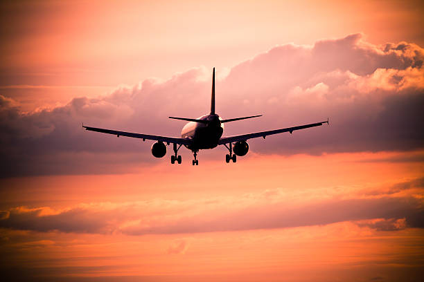 istock Airplane landing at sunset 475332381