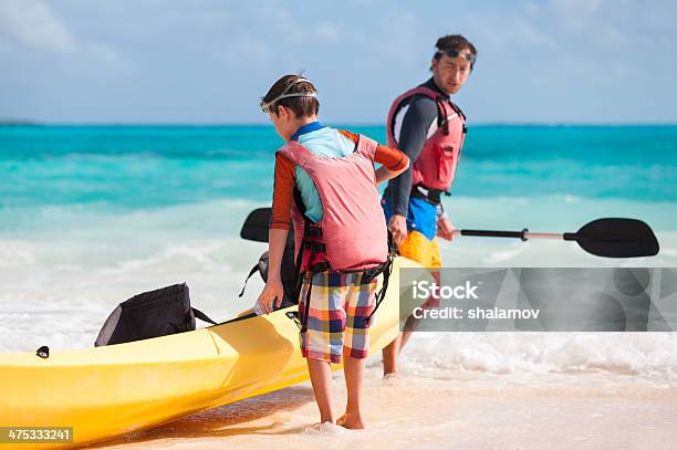 Father And Son Pulling Kayak Stock Photo - Download Image Now - Canoeing, Family, Activity