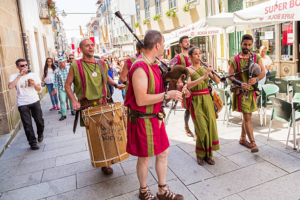 Roman folklore band playing the pipes and dancing Braga, Portugal - May, 23rd 2015: Roman folklore band playing the pipes and dancing through the streets. This roman festival depicting the period where romans named the city of Braga, Bracara Augusta its original roman name by César Augusto. braga portugal stock pictures, royalty-free photos & images