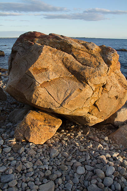 istock Large boulder on the beach at sunset in Groton, Connecticut. 475341558
